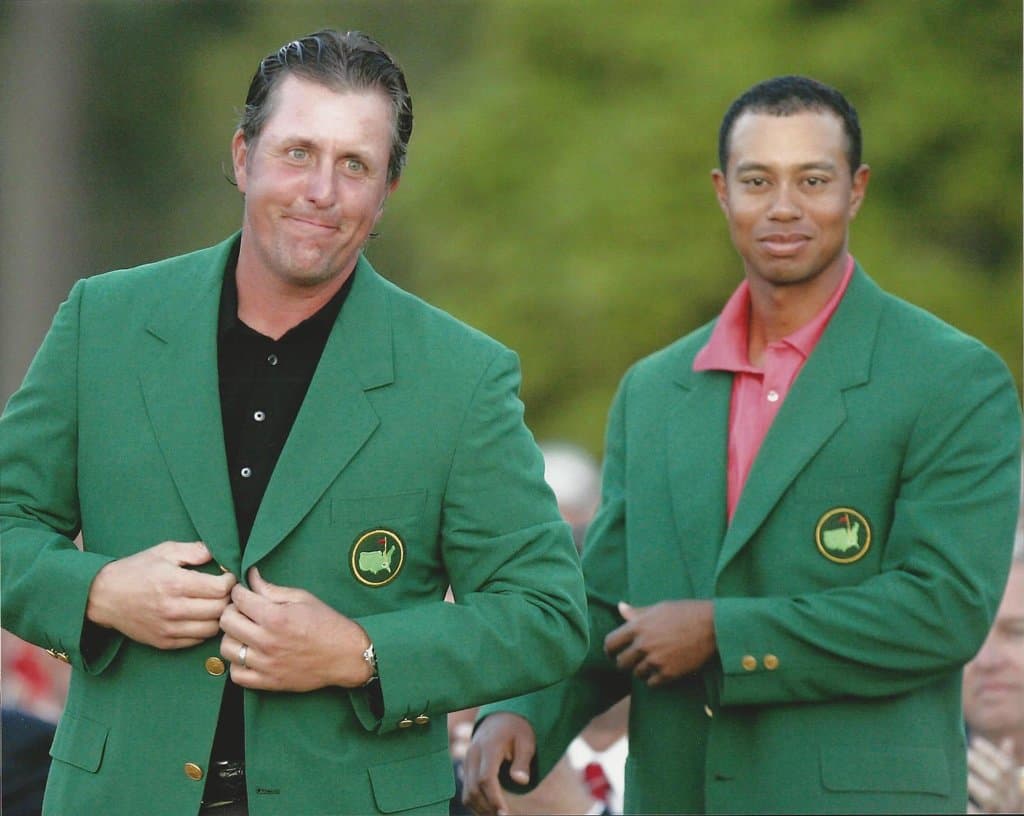 Phil Mickelson, left, gets his Masters Green Jacket from last years winner Tiger Woods after winning the 2006 Masters tournament at the Augusta National Club in Augusta, Ga., in this April 9, 2006 Photo Picture