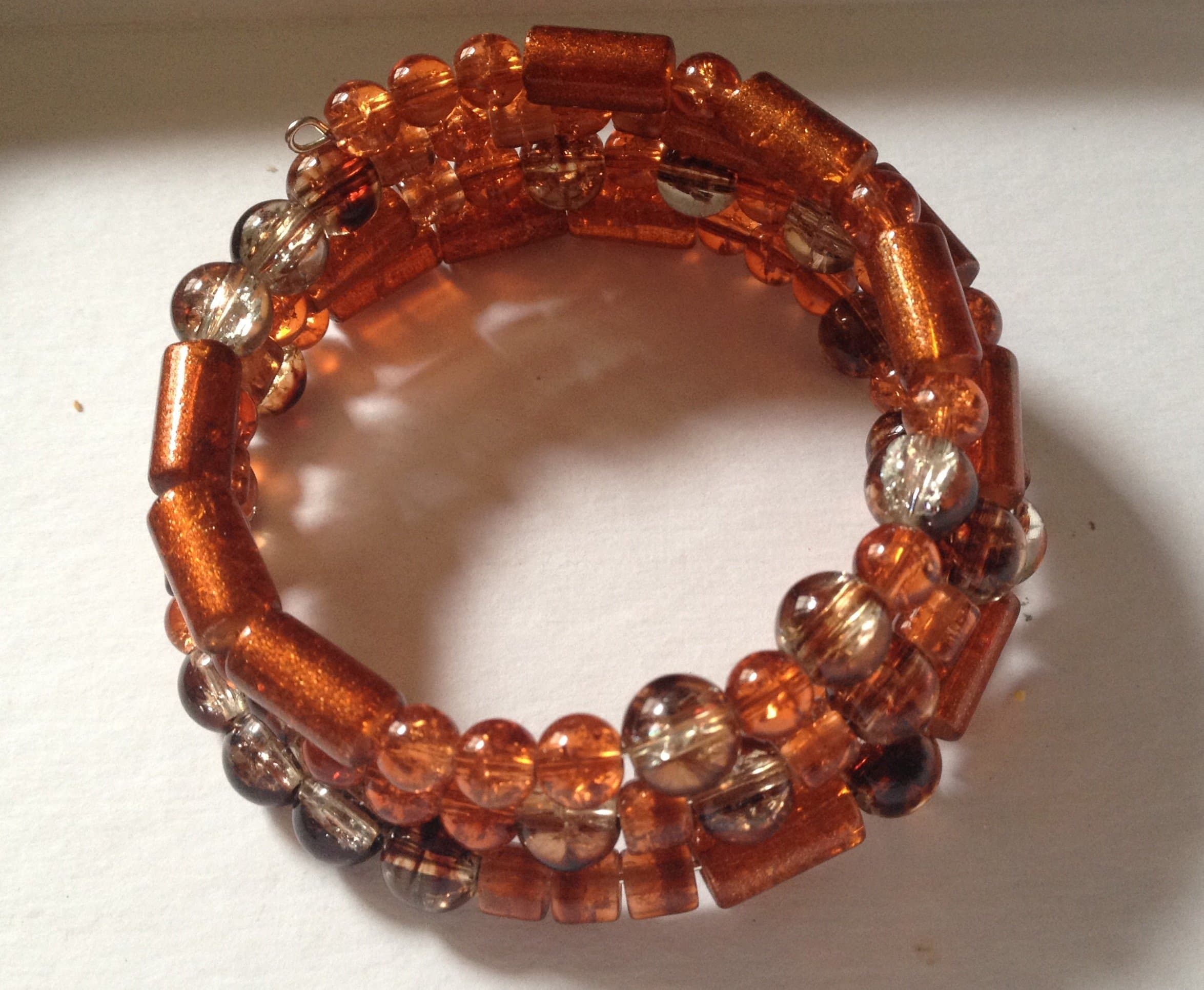Rusty orange, brown and clear glass beads wrap around bracelet