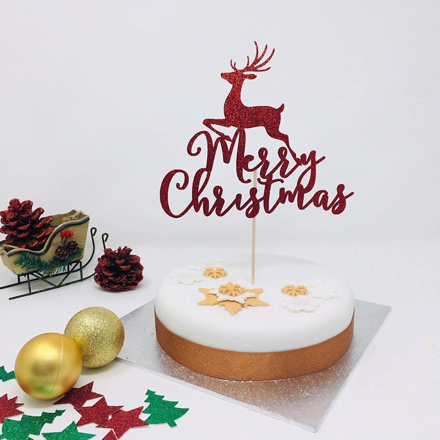 Merry Christmas cake topper with reindeer. Christmas cake decoration with red glitter topper. Christmas table decorations.